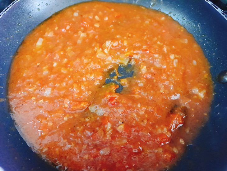 Frigideira com alho, cebola, pimentão, molho e temperos.