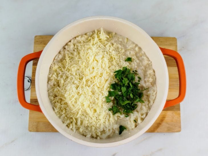 Parmesão e cebolinha adicionados na panela.