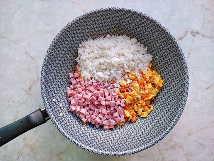Arroz e presunto adicionados na frigideira.