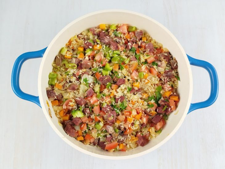 Legumes e cheiro-verde misturados ao arroz para distribuir os temperos.