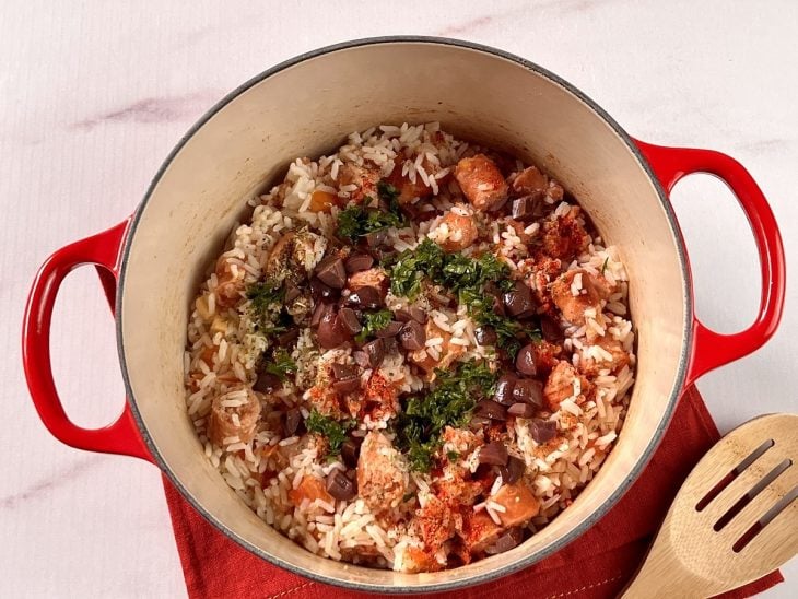 Uma panela contendo arroz com sobras de churrasco.