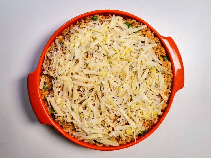 arroz transferido para um refratário, com queijo por cima para gratinar.