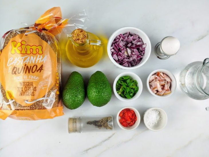 Ingredientes para a receita de avocado toast com ovo poché reunidos em uma bancada.