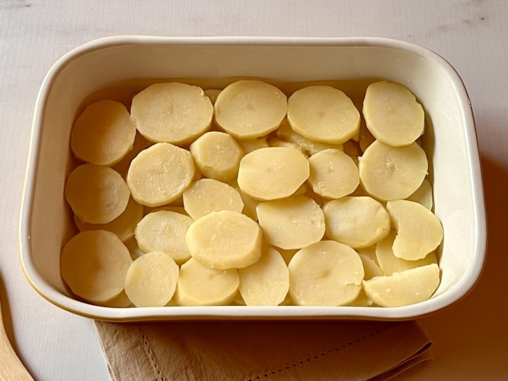 Um refratário forrado com as batatas.