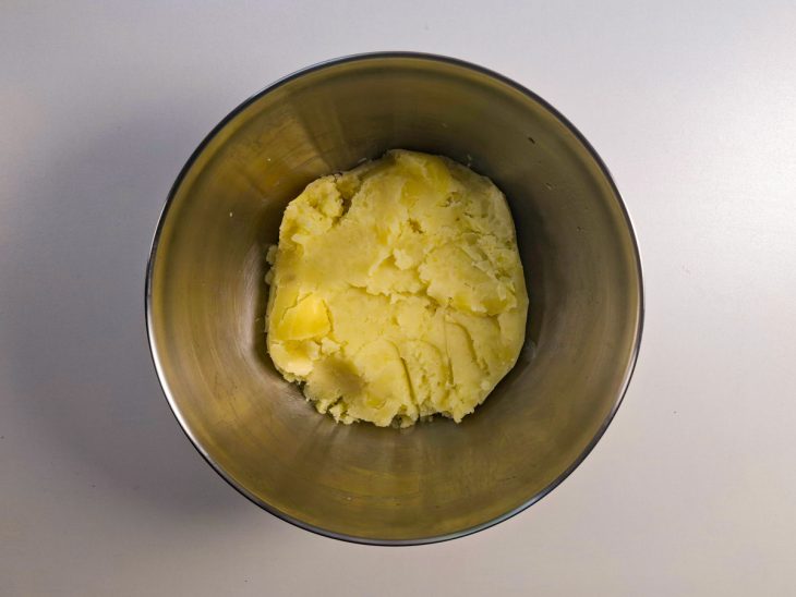 Batatas cozidas e amassadas em tigela.
