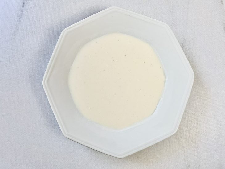 Um prato com água, farinha e temperos.