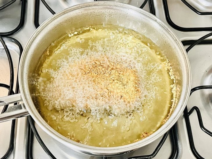 Panela com óleo e bife a fritar.