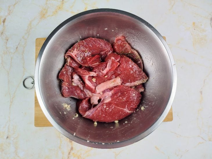 Bifes temperados em uma tigela.