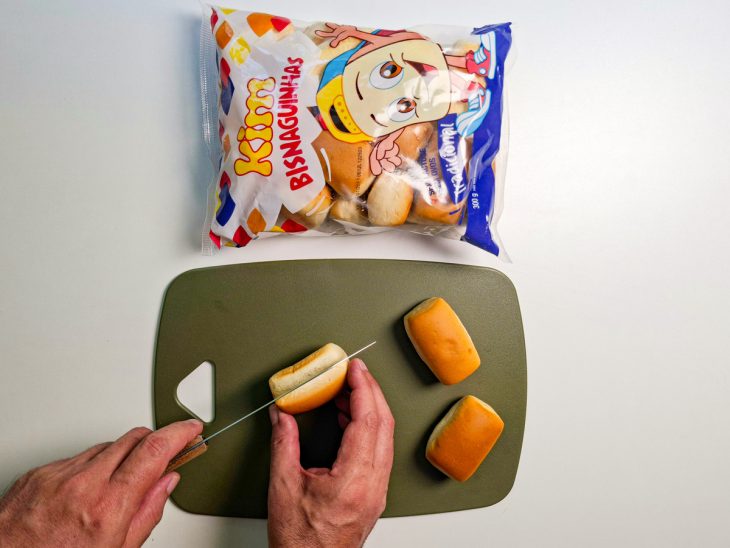 Bisnaguinhas sendo cortadas ao meio.