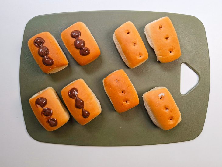 Metade das bisnagas recheadas, outras com furos para o recheio.