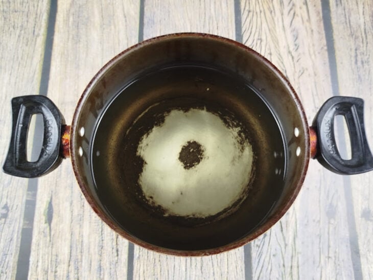 Óleo aquecendo em uma panela adequada para fritura.