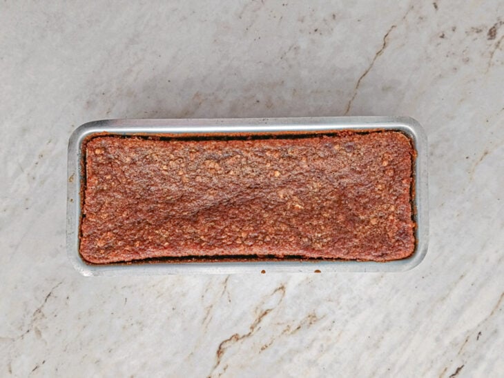 Bolo assado, dourado e crescido dentro da forma após o tempo de forno.