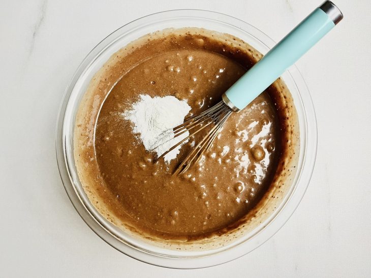 Mistura do liquidificador adicionada a tigela com farinha e chocolate.