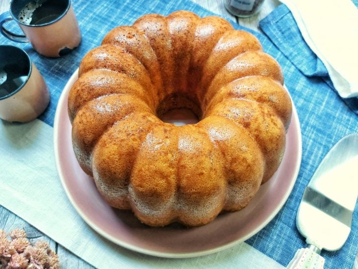 Um recipiente com bolo de fubá fofinho da vovó.