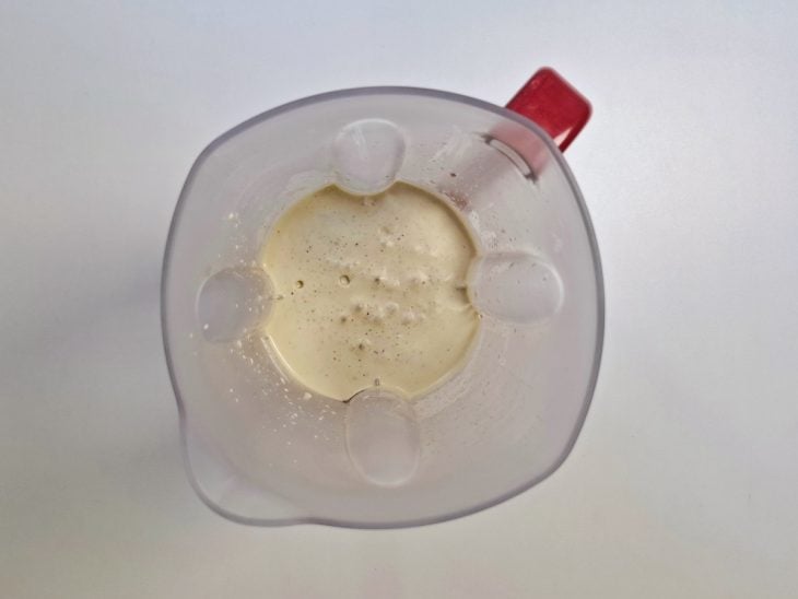 Um liquidificador com ovos, cascas das maçãs e óleo.