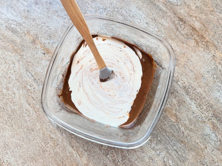 Creme de leite e chocolate sendo misturados.