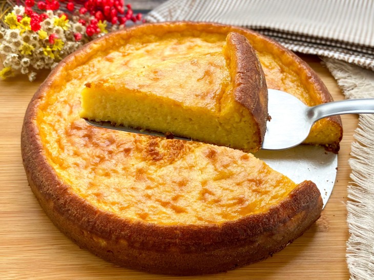 Bolo de pamonha de liquidificador com um pedaço sendo retirado.