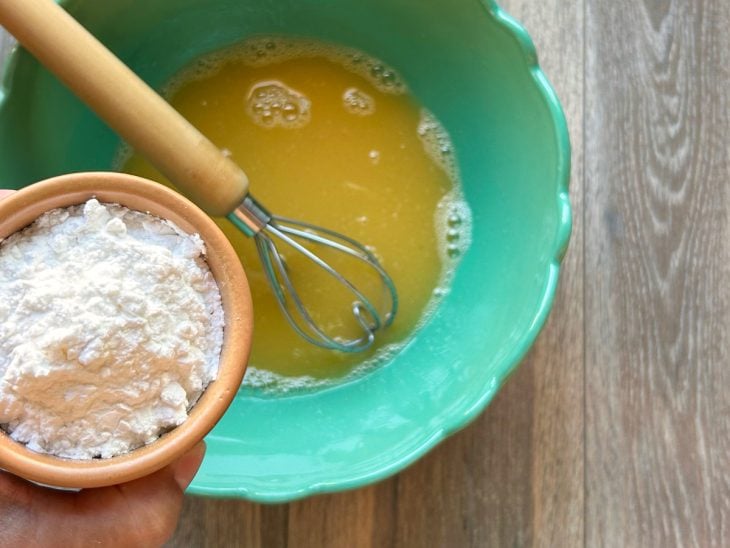 Maisena adicionada na tigela com ingredientes batidos.