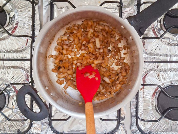Cebola sendo refogada no fundo da panela com os sabores da carne.