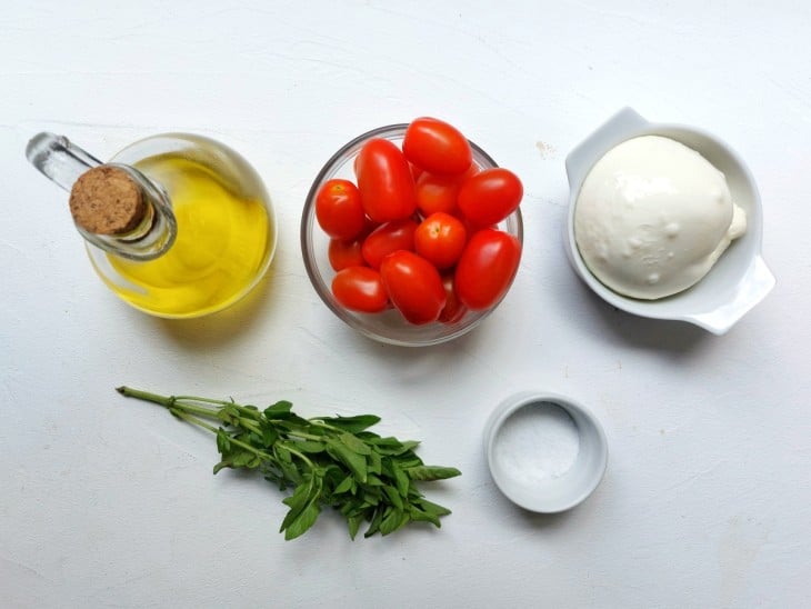 Todos os ingredientes da burrata gratinada reunidos na bancada.