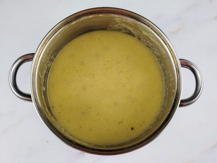 Creme de mandioca, sal e pimenta-do-reino adicionados a panela.