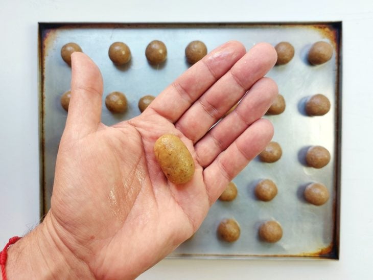 Brigadeiro de nozes sendo modelados em formato de camafeu.