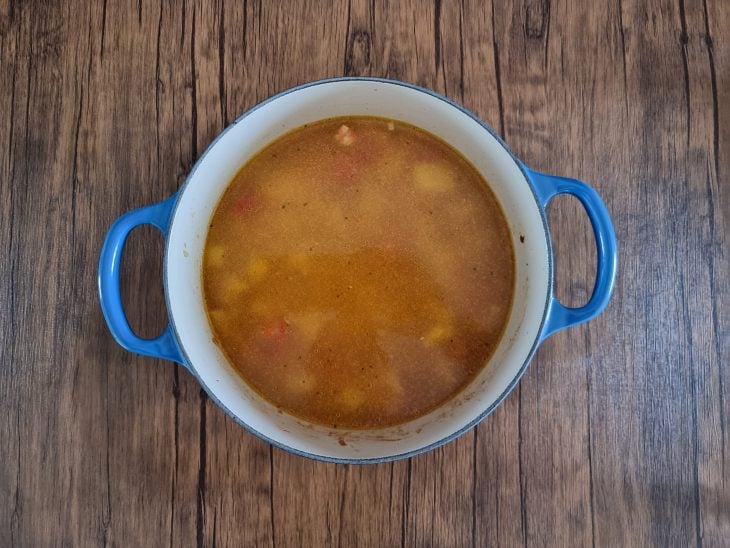 Panela com caldo de frango e batatas.