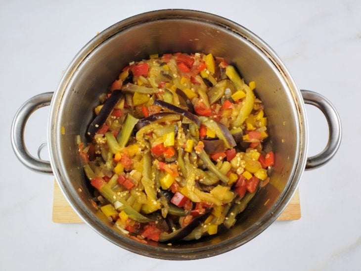Berinjela, tomate e sal adicionados e incorporados na panela.