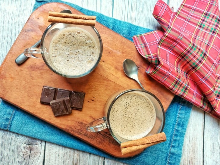 Uma tábua contendo dois copos com capuccino proteico.