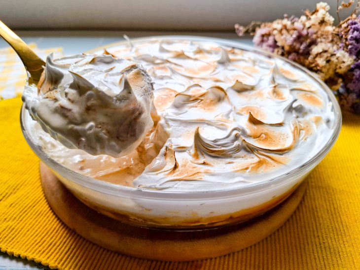 Bolo pronto, numa travessa o rendimento inteiro da receita. Uma fatia sendo tirada.