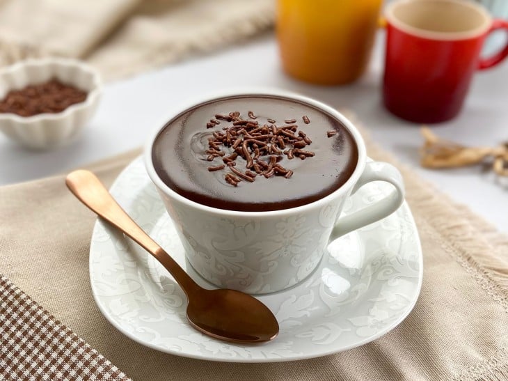 Chocolate quente com barra de chocolate finalizado com granulado.