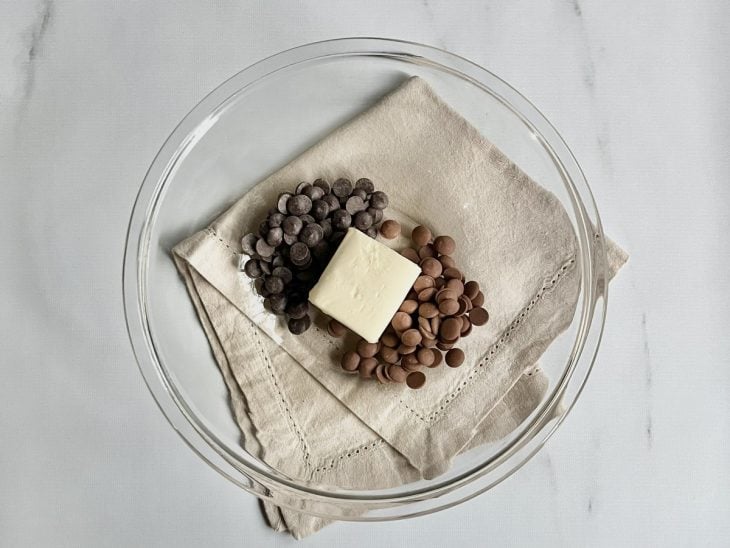 Gotas de chocolate e manteiga em uma tigela de vidro.