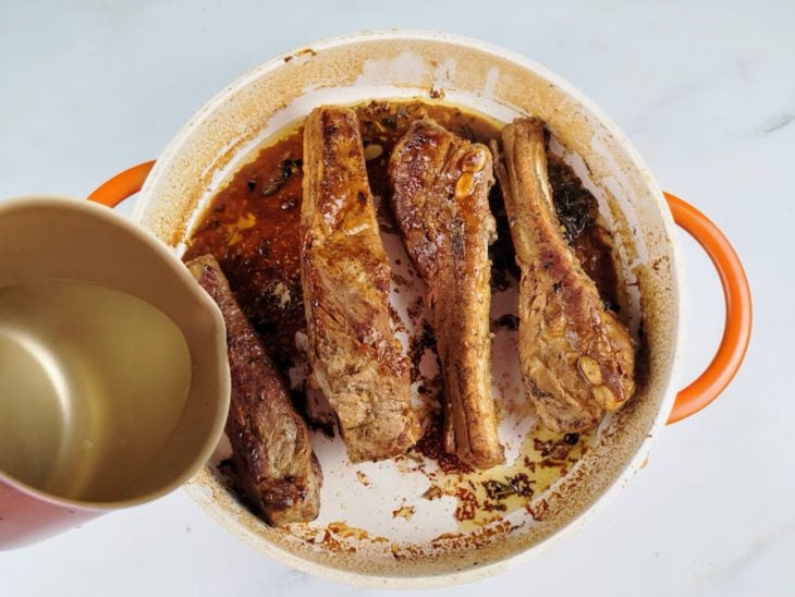 Panela com as costelinhas dourando com água.