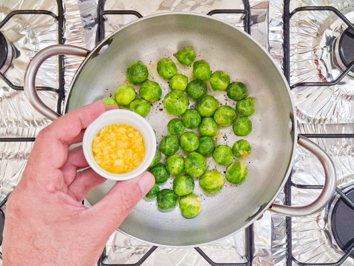 Alho picado sendo adicionado na panela.