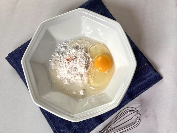 Um prato contendo a mistura de ovo, tapioca e sal.