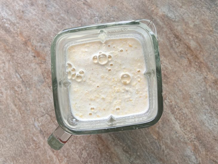 Milho e leite batidos no liquidificador.