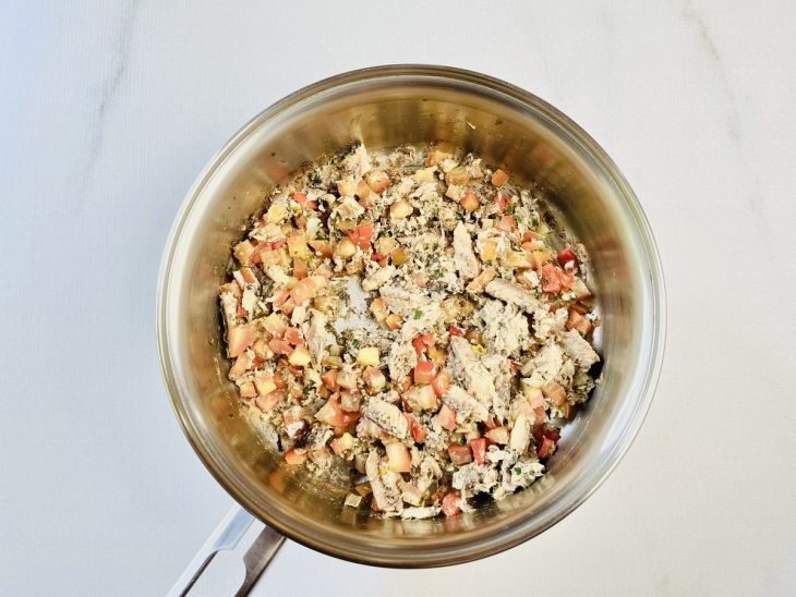 Sardinha refogada com ingredientes na panela.