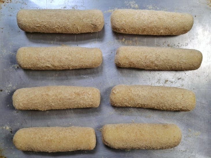 Enroladinhos empanados em uma forma.