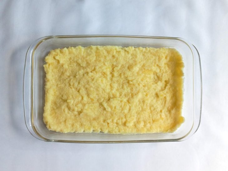 Purê de batatas acomodado em uma travessa retangular de vidro.