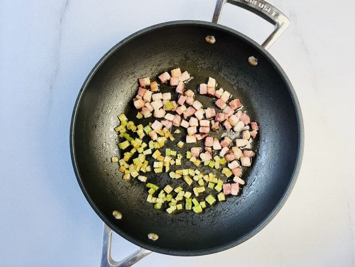 Talo de salsão adicionado na frigideira com bacon.