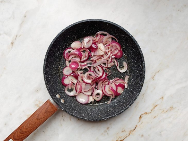 Cebola roxa sendo refogada.