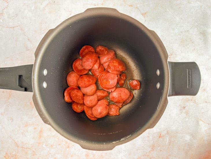 Calabresa frita na panela de pressão.