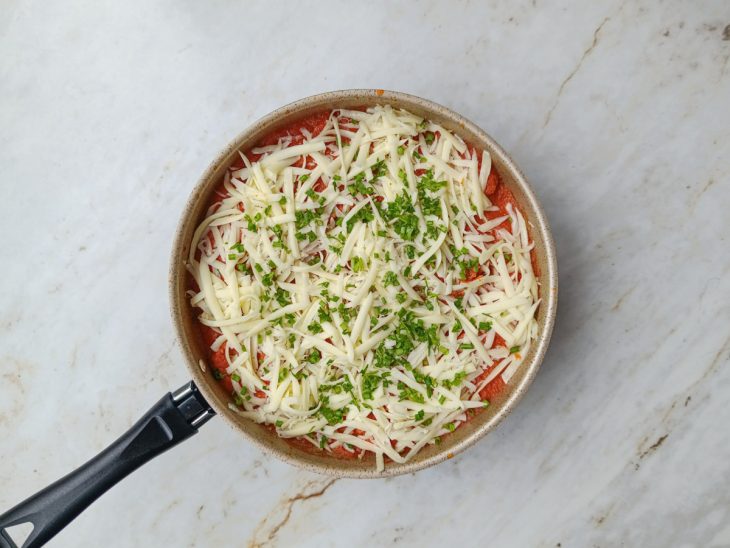Mussarela, cebolinha, salsinha e as folhas de manjericão adicionadas a parmegiana.