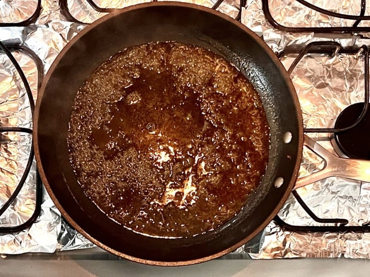 Uma frigideira com suco de laranja e mel.