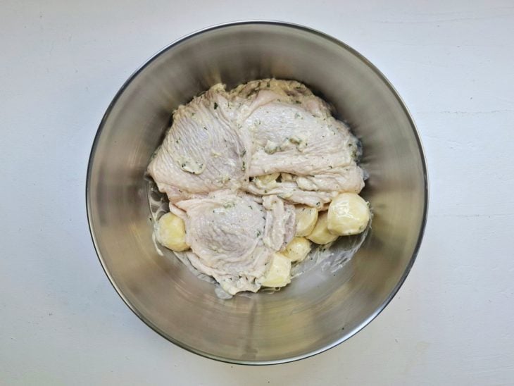 Tigela com batatas e frango temperados.