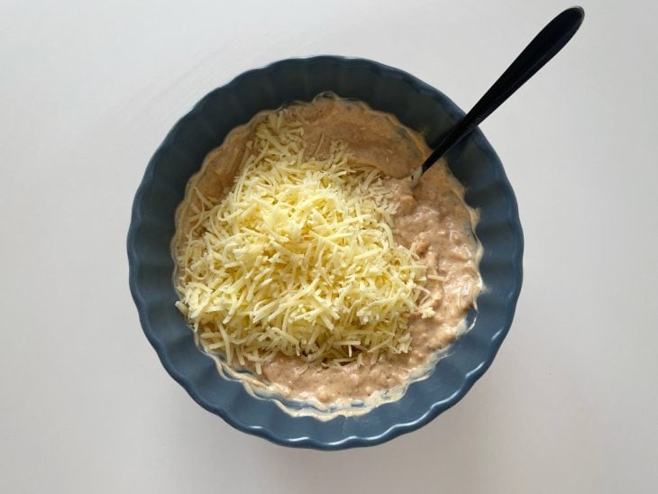 Queijo parmesão adicionado na tigela.