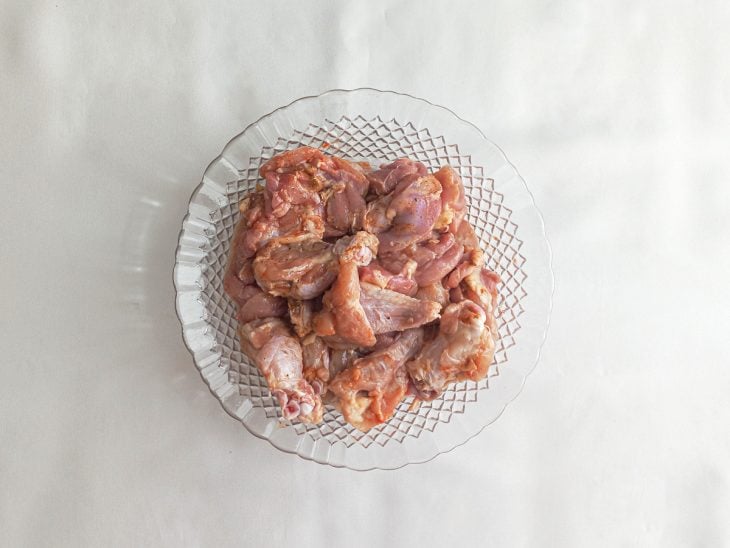 Frango cru temperado para marinar.