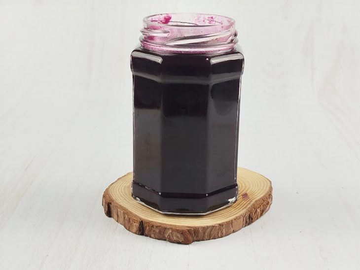 Geleia sendo colocada no pote de vidro esterilizado.