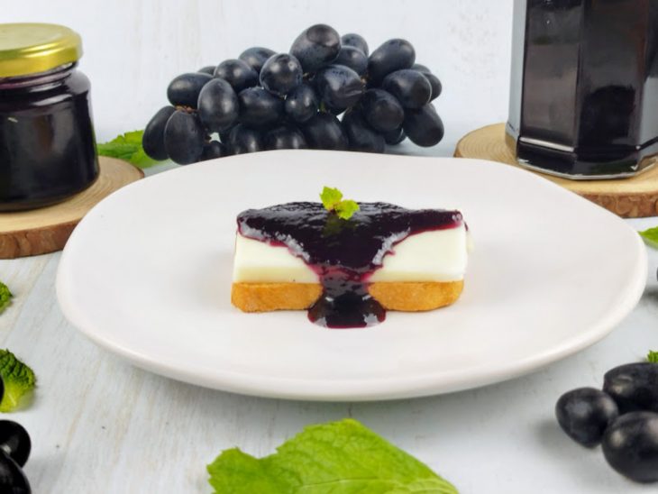 Geleia servida com torradas e queijo branco.