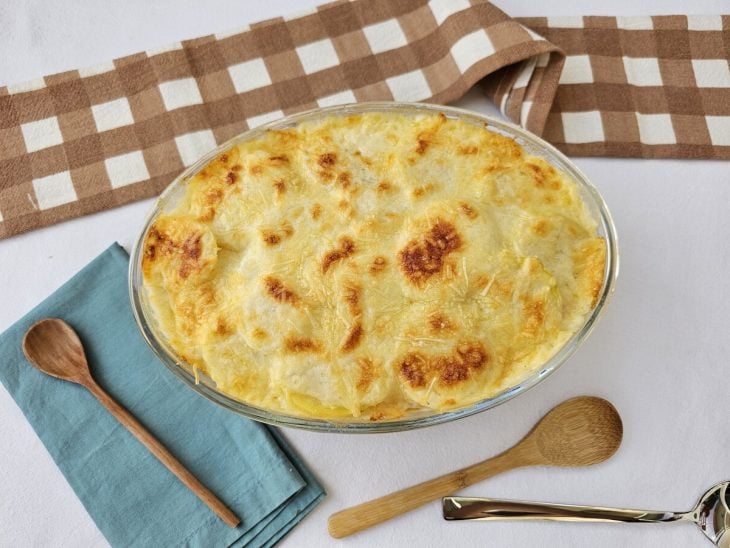 Um recipiente contendo gratinado de frango com batatas.